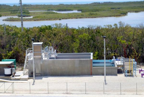 Looking down at the Layton wastewater treatment system. Purple and blue pipes extend out of the ground and system.